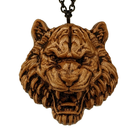 Wooden pendant necklace carved in the shape of tiger. Made from hard maple and hanging from a black stainless steel chain against a white background.