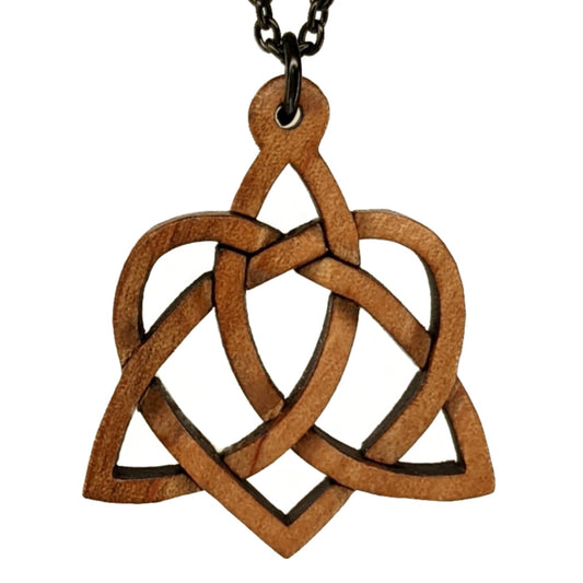 Wooden necklace pendant created in the style of a Celtic weave pattern that is a trinity and heart combined. The symbol represents adoption. Hanging from a black stainless steel chain against a white background.