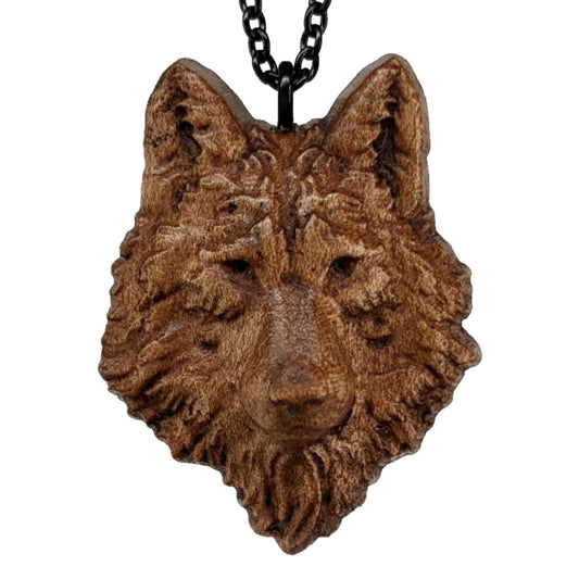 Wooden necklace pendant carved in the shaped of an wolf head. Made from hard maple wood. Hanging from a black stainless steel chain against a white background.