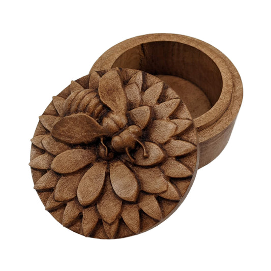 Round wooden box 3D carved with a honey bee rested atop a multi-layered flower. The bee is curved slightly off from the center of the flower as if searching for nectar. Made from hard maple wood with a brown stain against a white background.