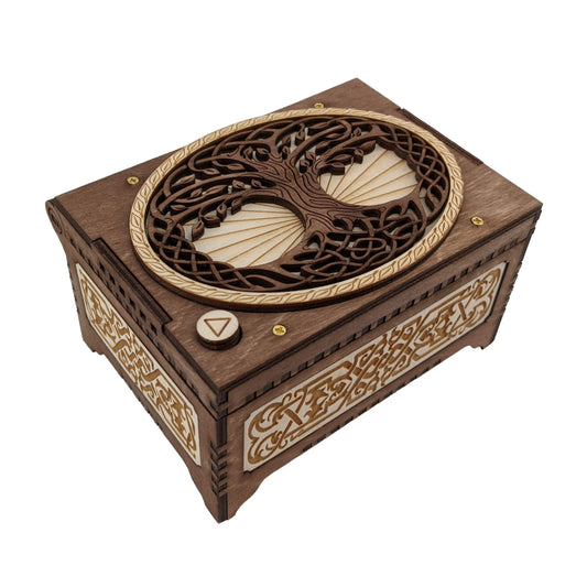 Celtic tree of life music box, dark brown and birch wood in color, with decorative filigree patterns engraved on the sides.