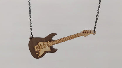 Electric guitar shaped wooden necklace pendant. Made from birch wood and stained dark brown.  Hanging and rotating from a black stainless steel chain against a white background.