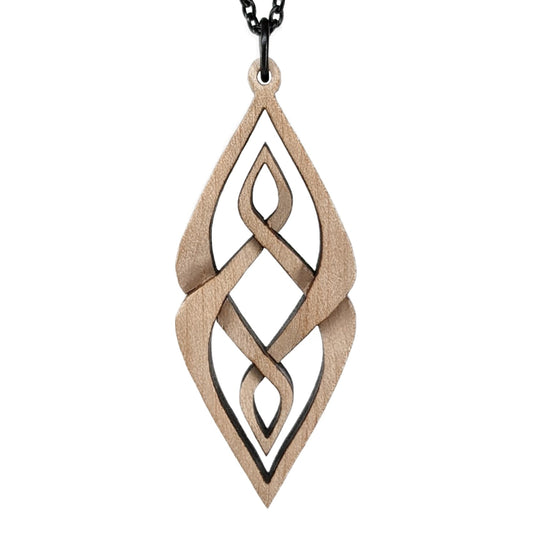 Wooden necklace pendant carved so that curving shapes weave into each other. Made from hard maple wood and hanging from a black chain against a white background.