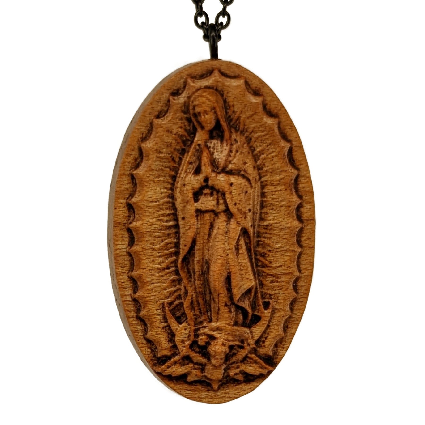 Wooden necklace pendant carved in the shape of Guadalupe. Made from hard maple and hanging from a black stainless steel chain against a white background.