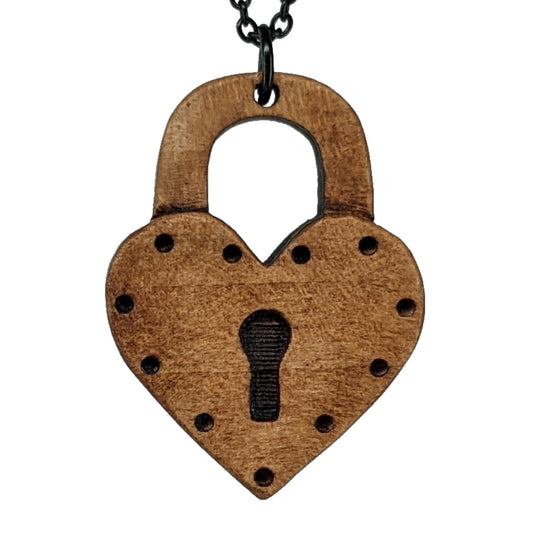 Round wooden necklace pendant carved in the shape a heart locket. Hanging from a black stainless steel chain against a white background.