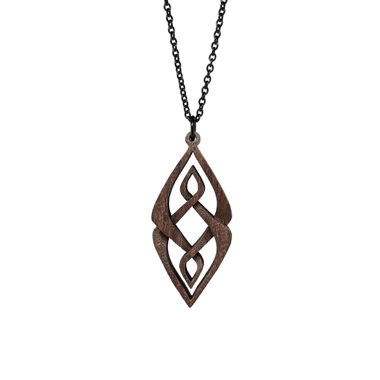 Wooden necklace pendant carved so that curving shapes weave into each other. Made from dark walnut wood and hanging from a black chain against a white background.