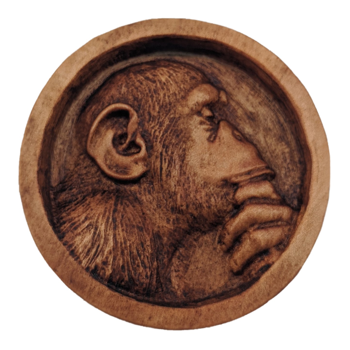 Round wooden box 3D carved with a recessed carving of a side profile view of an hairy ape rubbing his chin in his hand while in mid thought. Made from hard maple wood with a brown stain against a white background. Front view.