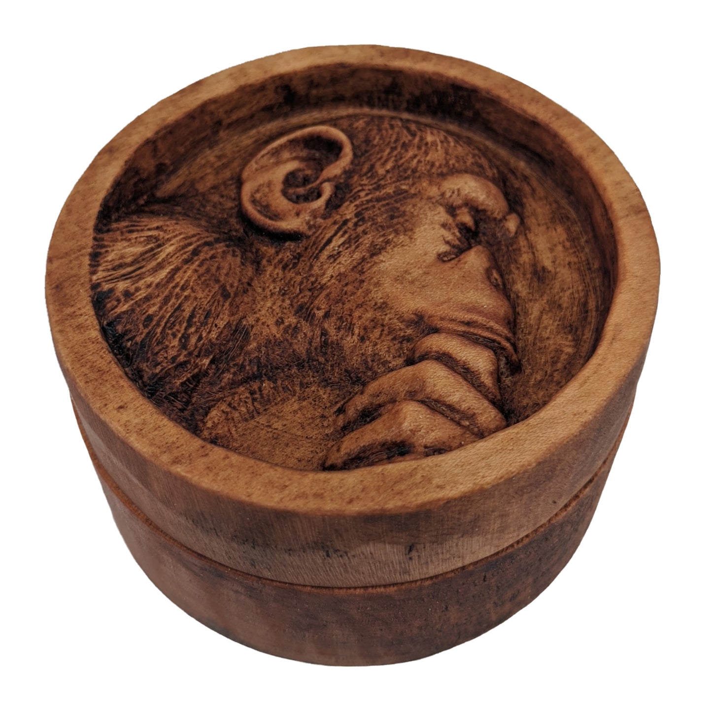 Round wooden box 3D carved with a recessed carving of a side profile view of an hairy ape rubbing his chin in his hand while in mid thought. Made from hard maple wood with a brown stain against a white background.