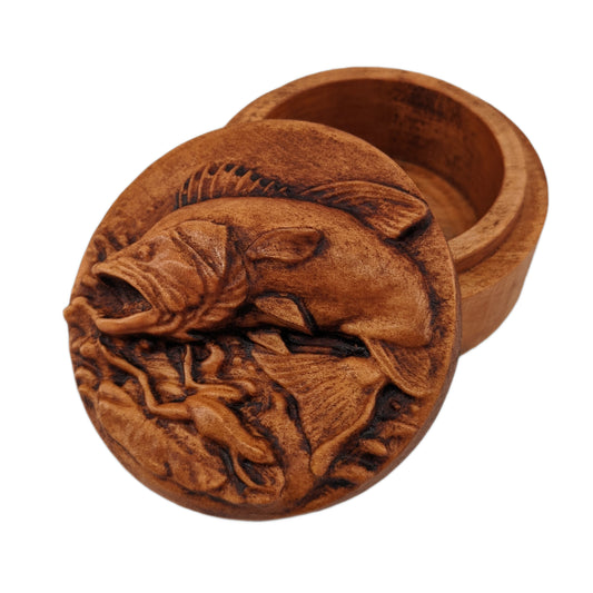 Round wooden box 3D carved with a large bass fish jumping out of the water chasing after a small frog that has narrowly avoided being caught. Both are overtop a watery splash. Made from hard maple wood with a brown stain against a white background.