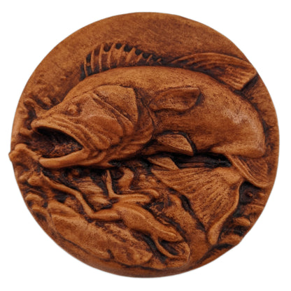 Round wooden box 3D carved with a large bass fish jumping out of the water chasing after a small frog that has narrowly avoided being caught. Both are overtop a watery splash. Made from hard maple wood with a brown stain against a white background.