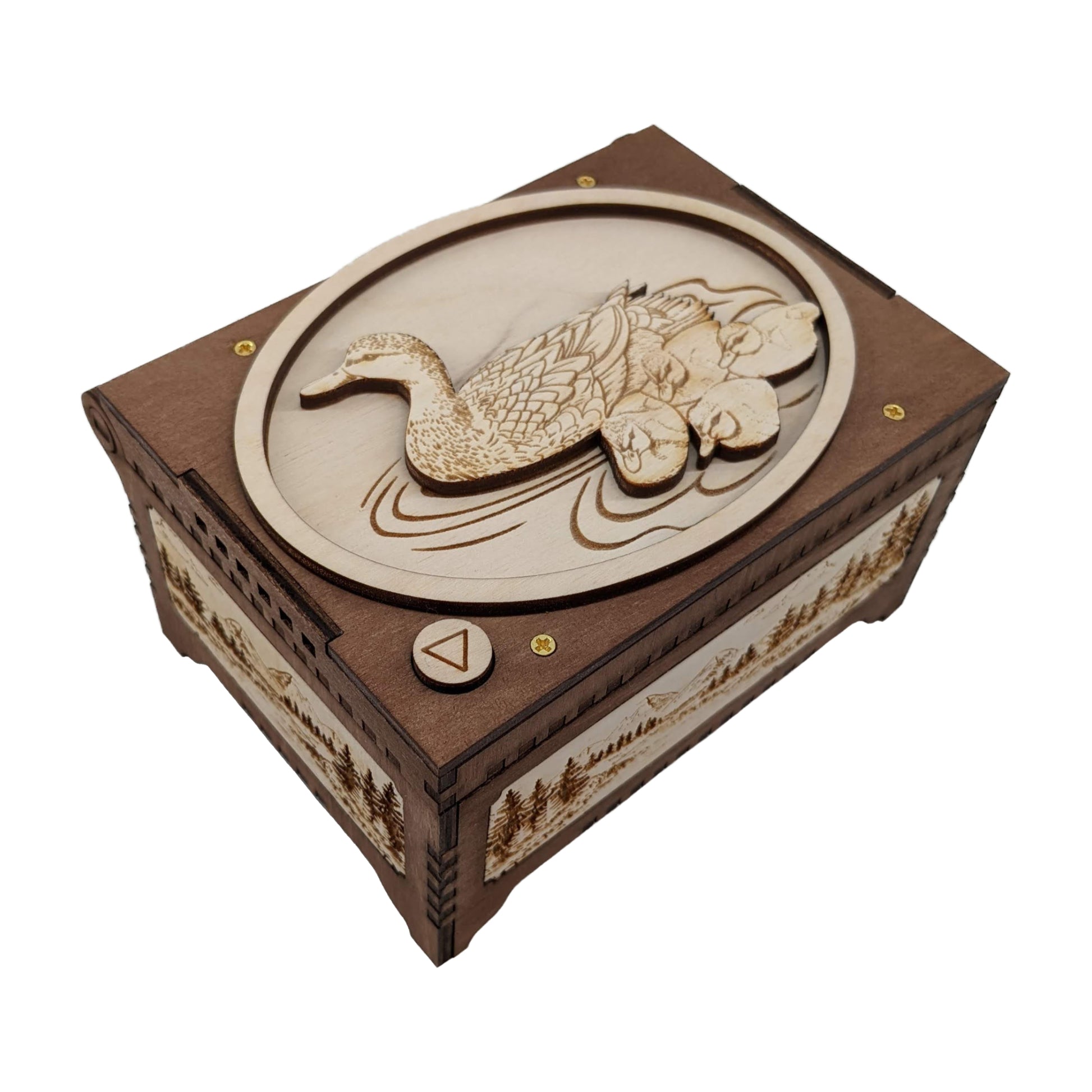 Mother duck and ducklings music box, dark brown and birch wood in color, with a peaceful scene of mountains, trees and a river engraved on the sides.