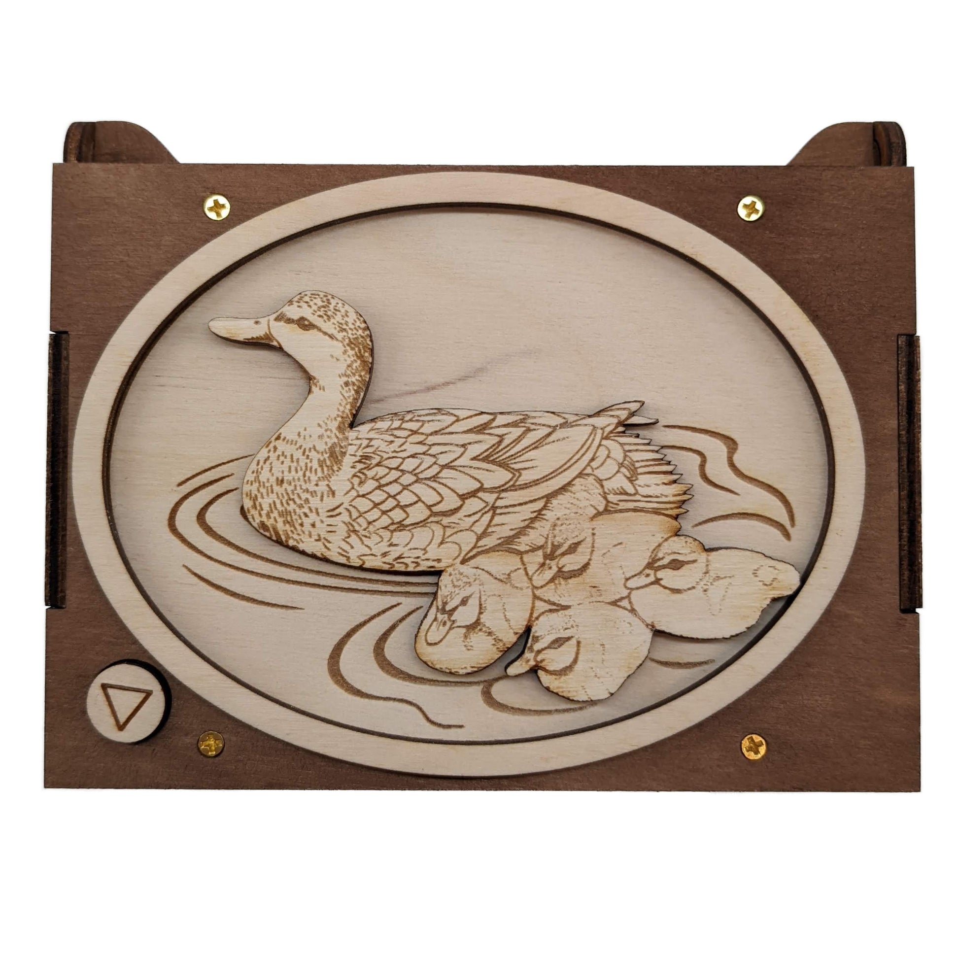 Top view of a mother duck and ducklings custom sound box, with the ducks happily sitting on water, engraved on light wood, with a dark wood border.