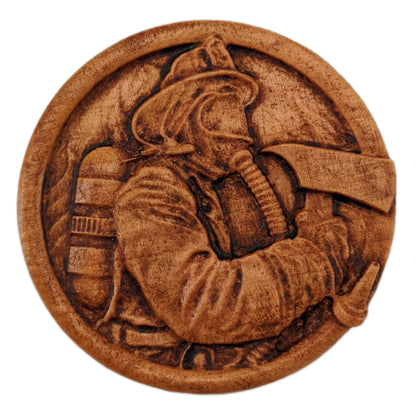 Round wooden box 3D carved with a firefighter in full gear with hat, oxygen tank, mask on and axe in hand within a fire hose border in front of a background of flames. Made from hard maple wood with a brown stain against a white background