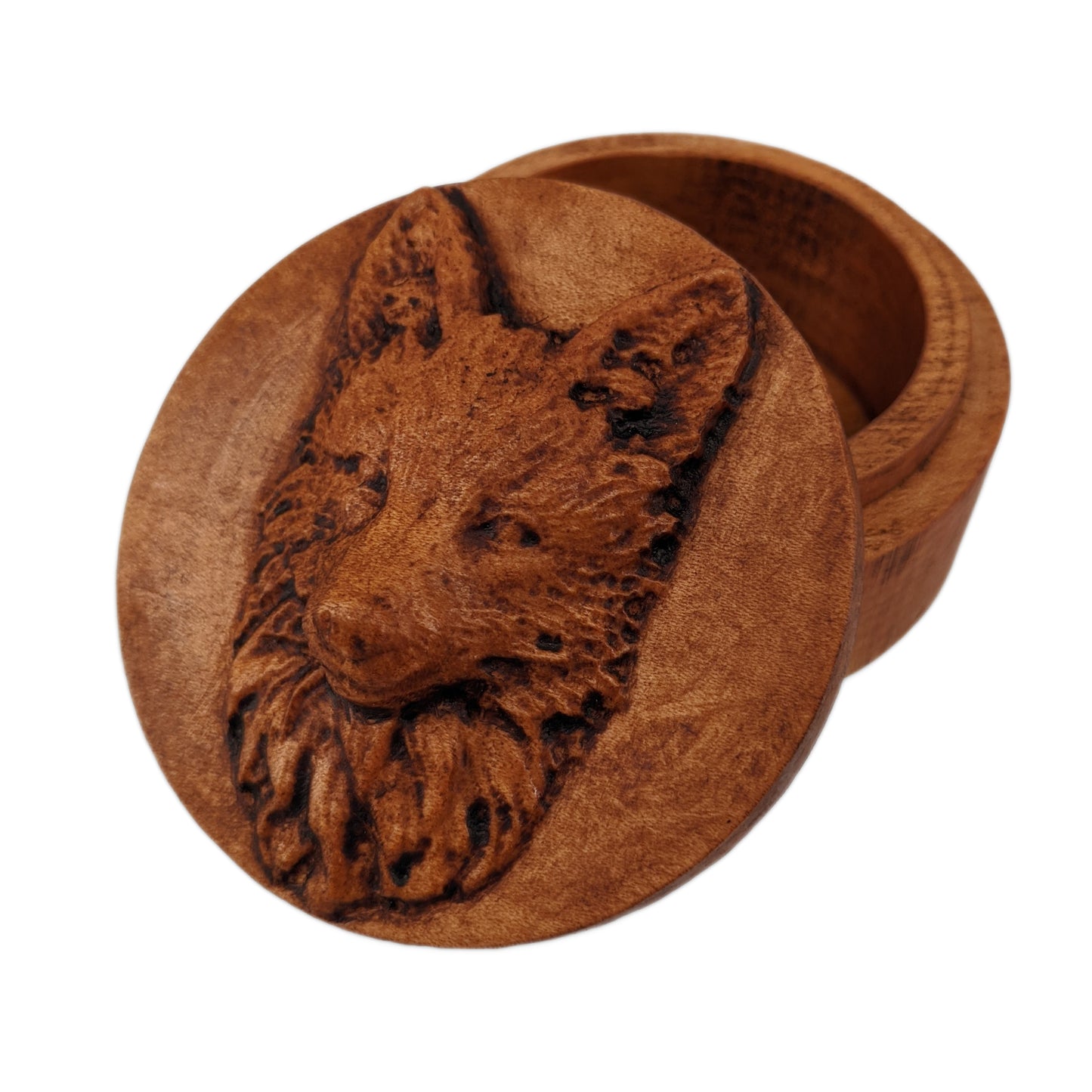 Round wooden box 3D carved with a fox face looking straight ahead. It has tall upright ears and a narrow face. Its fur is long and bushy around its mane and short near its nose. Made from hard maple wood with a brown stain against a white background.