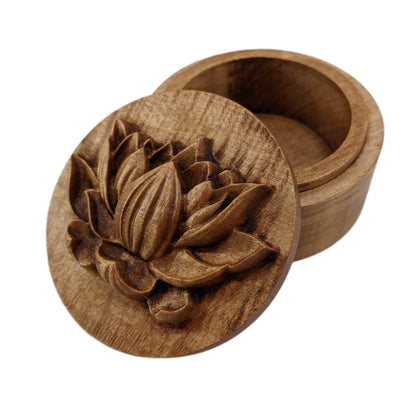 Round wooden box 3D carved with a side profile of a lotus flower. It has several layers of leaves closer to the bottom and layers of petals going up the flower to the pointed center. Made from hard maple wood stained brown against a white background.