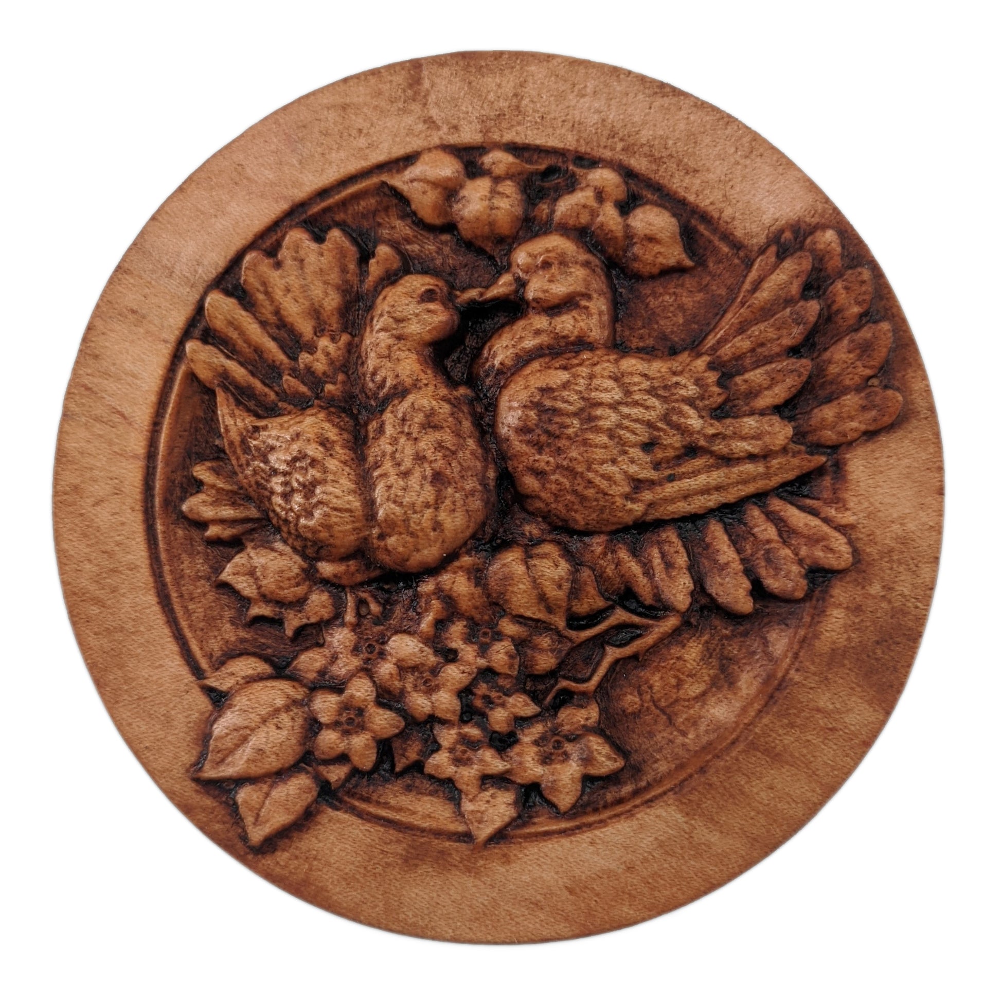 Round wooden box 3D carved with two lovebirds standing on a branch blooming with flowers, looking at each other with their beaks touching and feathers fluffed up. Made from hard maple wood stained brown against a white background.