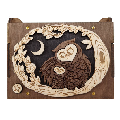 Top view of the owl themed keepsake music box, showing the sweet mother owl hugging the baby owl to her, while sitting in a tree against a night sky.