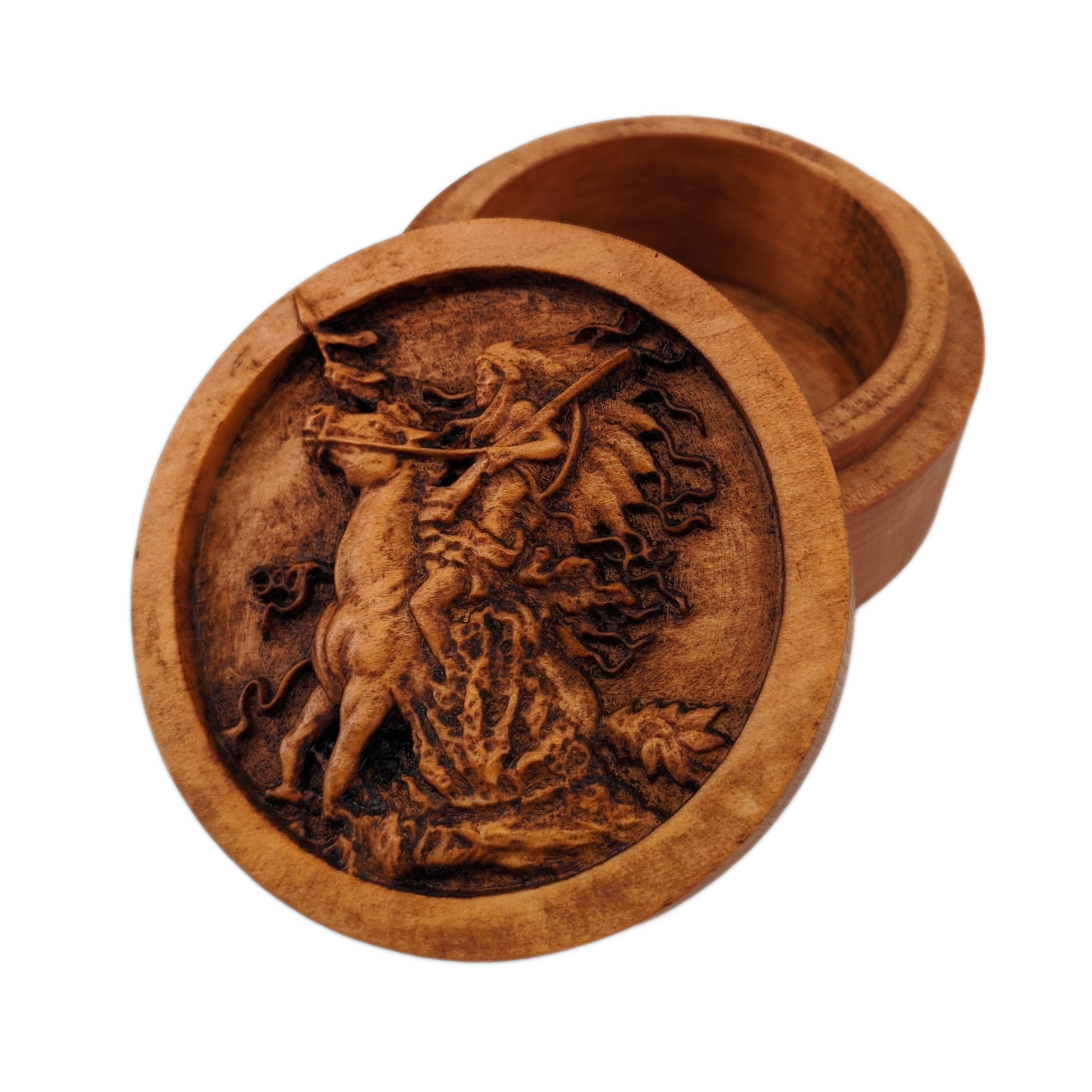 Round wooden box 3D carved with a native american warrior on horse rearing up in some shrubbery. Has big headdress. Holding reins and gun shouldered in one hand, spear in the other. Made from hard maple wood stained brown against a white background.