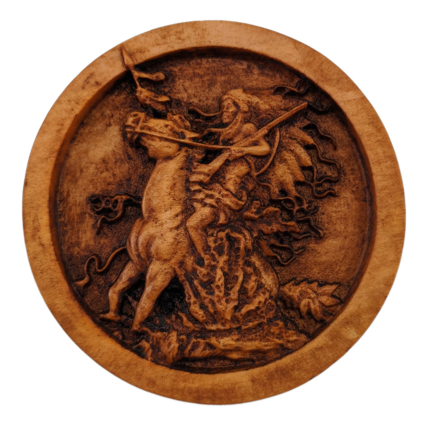 Round wooden box 3D carved with a native american warrior on horse rearing up in some shrubbery. Has big headdress. Holding reins and gun shouldered in one hand, spear in the other. Made from hard maple wood stained brown against a white background.