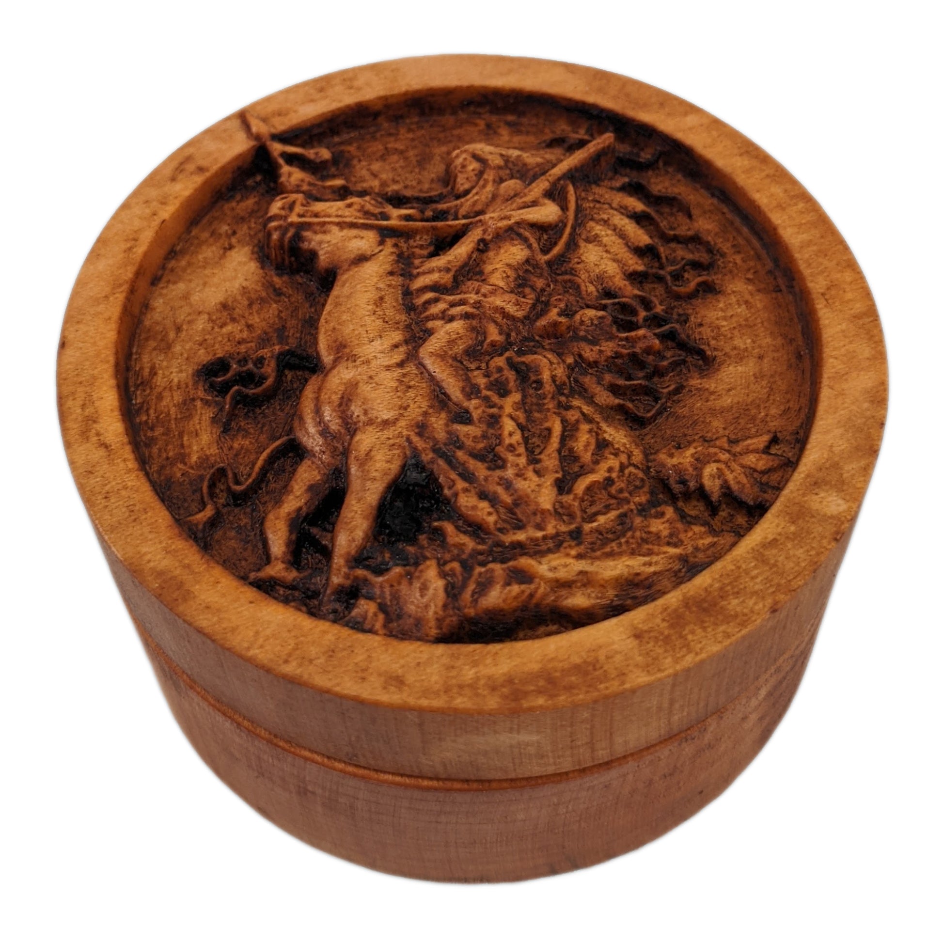 Round wooden box 3D carved with a native american warrior on horse rearing up in some shrubbery. Has big headdress. Holding reins and gun shouldered in one hand, spear in the other. Made from hard maple wood stained brown against a white background.