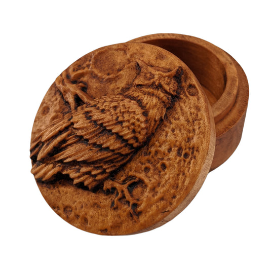 Round wooden box 3D carved with an owl sitting on a jagged branch in front of a full moon filled with craters. The owl has pointed ears and layers of intricately carved feathers. Made from hard maple wood stained brown against a white background.