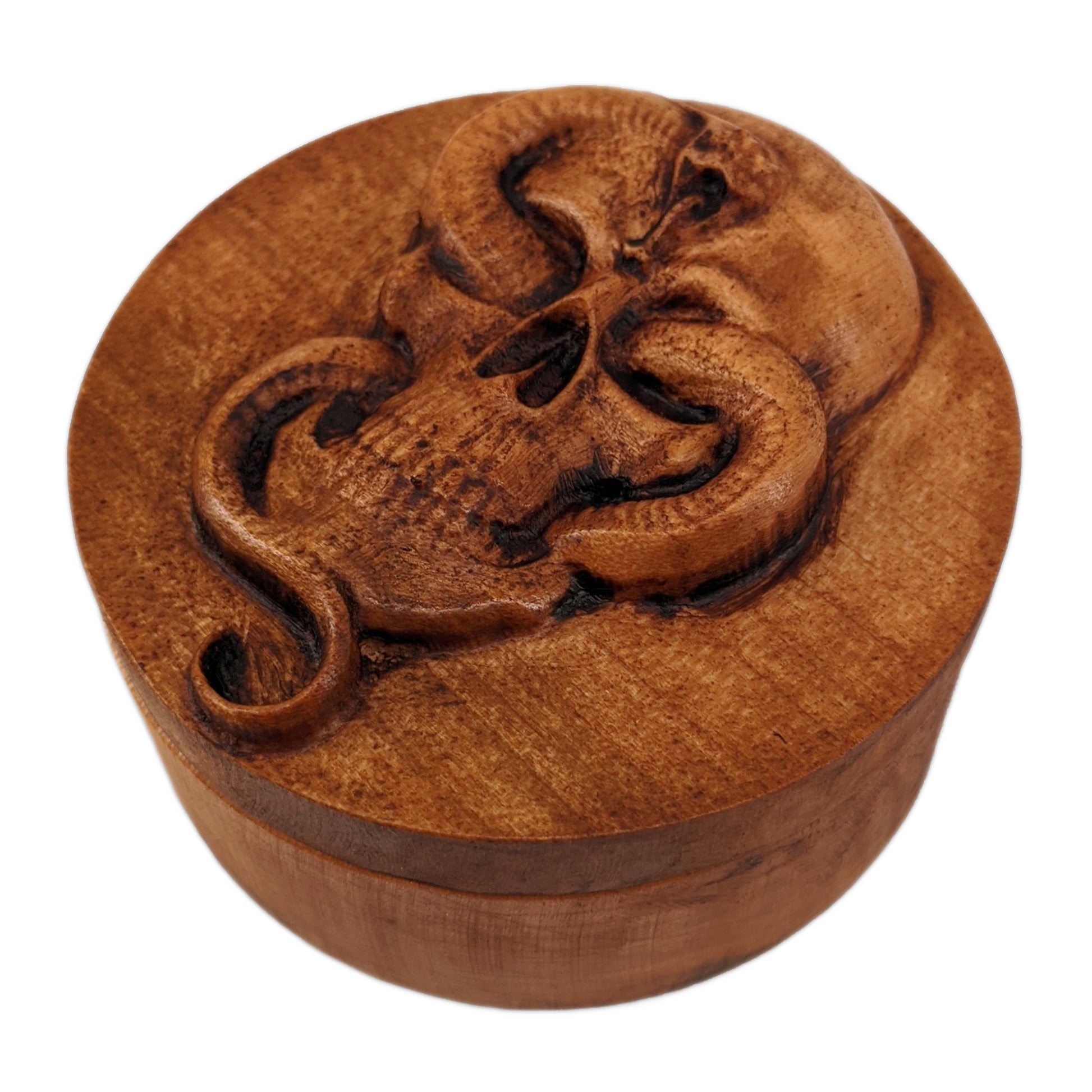 Round wooden box 3D carved with a Large skull facing forward with a snake intertwined through its jaw bone and eye sockets. The snake is looking forward hissing with its tongue out. Made from hard maple wood stained brown against a white background.