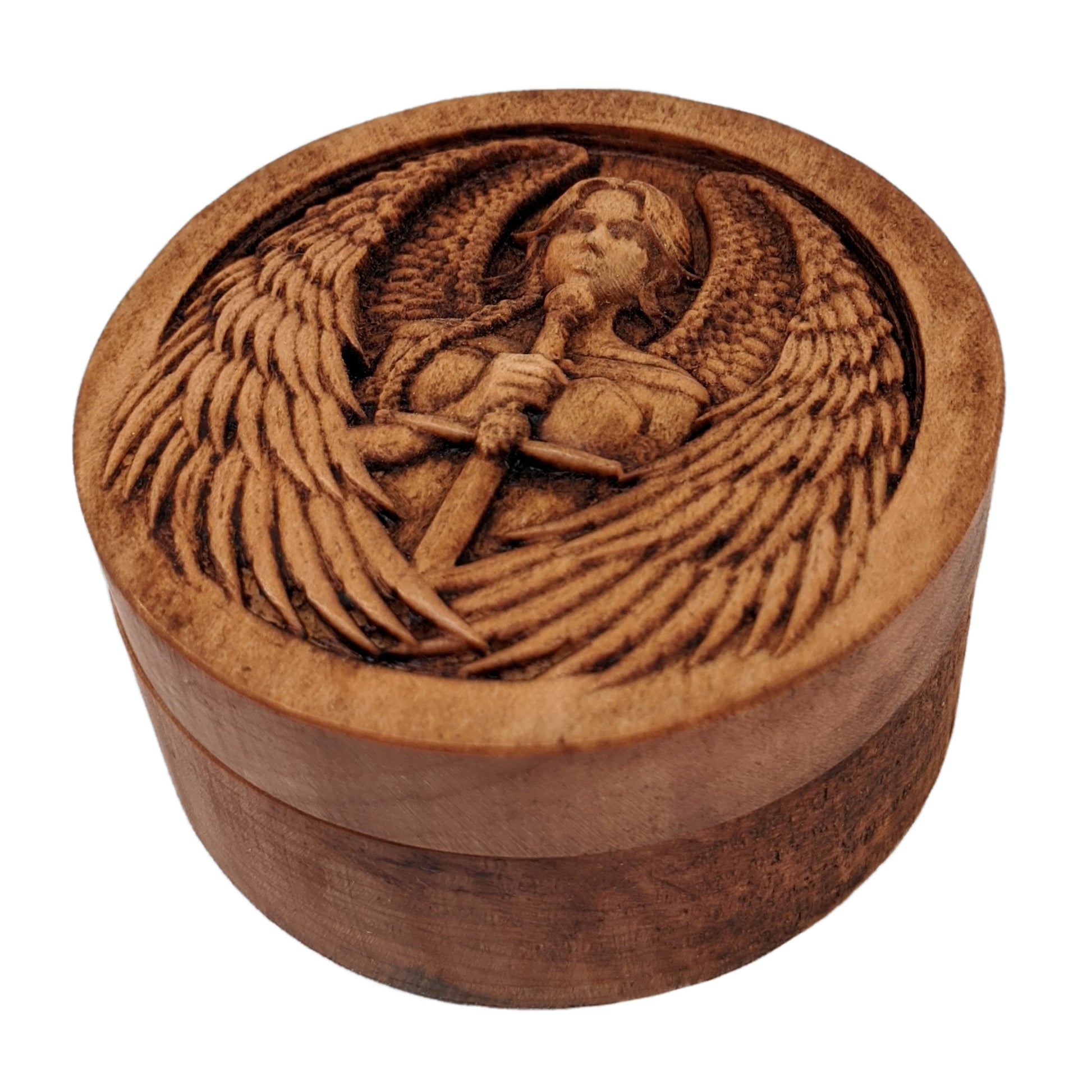 Round wooden box 3D carved with a warrior angel with a serious face and a sword straight down in front. She has parted bangs and large intricately layered wings with sharp tips. Made from hard maple wood stained brown against a white background.