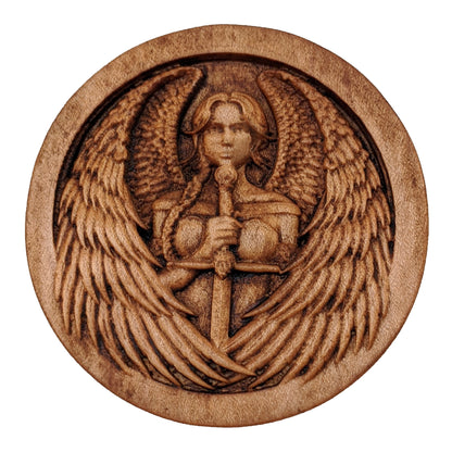 Round wooden box 3D carved with a warrior angel with a serious face and a sword straight down in front. She has parted bangs and large intricately layered wings with sharp tips. Made from hard maple wood stained brown against a white background.